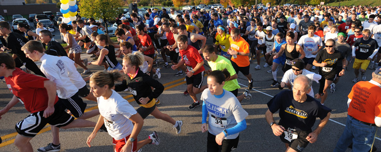 <p>Bowman Cup race participants run through the starting line as Homecoming events get underway Saturday morning.</p>