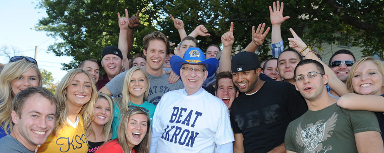 <p>President Lester A. Lefton enlists the help of Kent State fraternities and sororities in celebrating school spirit, prior to the start of the Kent State Homecoming football game.</p>