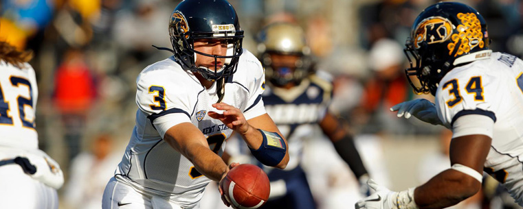 <p>Kent State's quarterback hands off the football in 2011.</p>