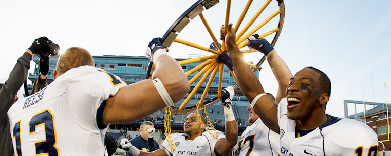 <p>Kent State players celebrate a victory and another to hold the Wagon Wheel in 2011.<br />
</p>