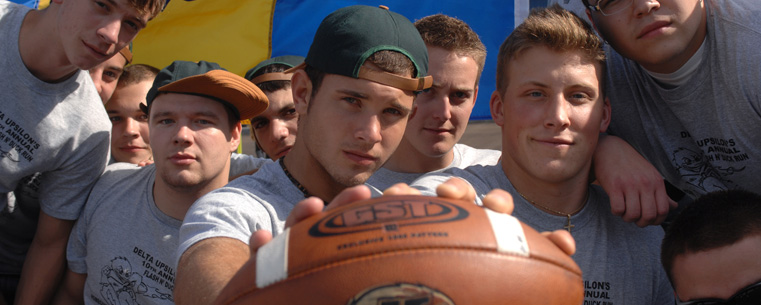 Students take a break from playing football before a game at Dix Stadium.<br />