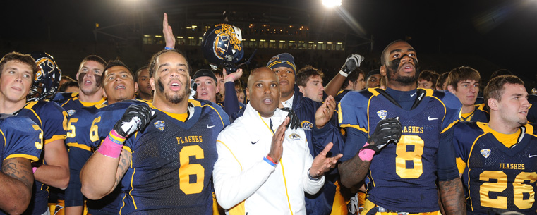 Kent State head football coach Darrell Hazell joins the team in singing the Kent State fight song after defeating the University of Akron.