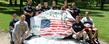 Members of the Kent State University Veteran's Campus Club pose around the rock on front campus.