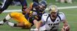 <p>A Kent State defensive lineman strips the ball from the Akron Zips quarterback in the end zone, resulting in a Kent State touchdown, ensuring a 28-17 victory during the Homecoming game at Dix Stadium.</p>