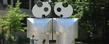 Students inspect the sculpture "Eye to Eye" by Barry Gunderson in front of Kent Hall.