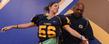 <p>Clifton Ragin Jr., head equipment manager for Kent State Golden Flashes football team, shows the proper way to wear shoulder pads during the Women’s Football Clinic.<br />
</p>