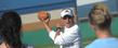 <p>Kent State Golden Flashes assistant coach Brian Rock shows the proper way to hold a football to get the right spin out of it when throwing.</p>