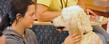 A Kent State student pets a dog during the Stress-Free Zone event held in the lobby of the library during finals week.