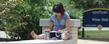 A Kent State University student studies near White Hall, home of the College of Education, Health and Human Services.