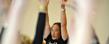 Rodney Yee, a well-known yoga expert and co-director of the Urban Zen Integrative Therapy Program, helps people do yoga poses during a workshop in the Kent Student Center.