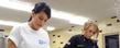 Two Kent State student volunteers of the Campus Kitchen at Kent State University chop lettuce in the kitchen in Beall Hall.