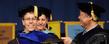 <p>A doctoral candidate is hooded during commencement ceremonies.</p>