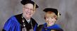 <p>President Lester A. Lefton compares university medallions with commencement speaker Virginia Horvath, following the advanced degree ceremony in the Memorial Athletic and Convocation Center.<br />
<br />
</p>