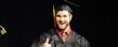 A graduating student flashes the "thumb's up" sign to his parents after receiving his diploma Saturday morning, in the Memorial Athletic and Convocation Center.