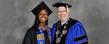 A Kent State graduate poses for a photograph with President Lester A. Lefton following commencement ceremonies in the Memorial Athletic and Convocation Center.