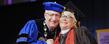 President Lefton embraces benefactor Roe Green after presenting her with the university medallion during commencement ceremonies.