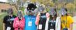 Kent State students and their siblings pose with cutout masks during Lil’ Sibs Weekend last year.