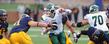 Kent State defensive players swarm around, and sack, the Eastern Michigan Eagle's quarterback at Dix Stadium.