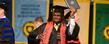 <p>A Kent State graduate celebrates during the morning commencement ceremony.<br />
</p>