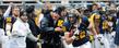 Kent State's Tim Erjavec rides the sideline after a catch, cheered on by teammates, during Kent State's 35-24 win over the University of Akron.