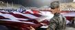 A member of the Kent State Air Force ROTC helps hold a large American flag during the halftime Heroes' Night commemoration during a home football game at Dix Stadium.