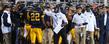 <p>Coach Darrell Hazell and staff compliment players on a good play.</p>