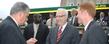 <p>Ray LaHood, secretary of the U.S. Department of Transportation, examines a pin presented to him by Kent State University President Lester A. Lefton and Kent City Manager Dave Ruller, right, during a visit to Kent's Acorn Alley.</p>