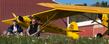 Pilots Joe Murray and Ron Siwik are pictured at the Portage County Airport with the two 1946 Piper J3 Cub aircraft they will fly to Dayton-Wright Brothers Airport. The two aviators plan to make consecutive landings in all of Ohio’s 88 counties. They will spend more than 26 hours aloft on the 1,670 nautical mile flight to honor the 75th anniversary of the Piper Cub. (Photo courtesy of Gary Harwood)