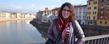 Kent State University student Lydia Coutré stands on a bridge over the Arno River in Pisa, Italy, near the Santa Maria dellaSpina Church.