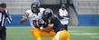 With Kent State head football coach Darrell Hazell watching in the background, safety Sal Battles (2) makes a tackle against teammate Larry Dawson (20) during the Kent State Football Spring Game.