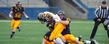 Defensive end Andrew Christopher brings down running back Larry Dawson during the Kent State Football Spring Game at Dix Stadium.