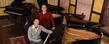 Music professors Jerry Wong and Donna Lee with Steinway pianos at Steinway Hall, in Akron.