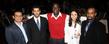 A group of friends gather for a photo during a student awards dinner.