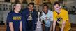 Kent State student-athletes gather around the 2012-13 Reese Trophy in the Memorial Athletic and Convocation Center. Pictured are wrestler Mack McGuire, basketball player Devareaux Manley, football wide receiver Tyshon Goode and cross country runner Samuel Allen.