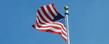 The American flag waves in the breeze in Risman Plaza after being raised by Kent State ROTC students participating in the annual Veterans Day ceremony.