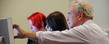 Kent State students receive instruction from a professor in a web sciences classroom in Franklin Hall.