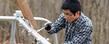 A Kent State student volunteer works on repairing playground equipment in East Liverpool during a Kent State alternative spring break trip.