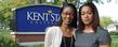 Gina Stikes-Shoehalter and her sister, Joan Stikes-Jenkins pose in front of the Kent State sign near Franklin Hall.