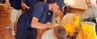 <p>Kent State baseball player David Starn signs the shirt of a young baseball player from Kent.</p>