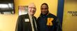 President Lester A. Lefton poses for a photo with Joshua Cribbs in the president's loge at Dix Stadium.