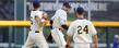 Kent State players (left to right) George Roberts, Jimmy Rider and Sawyer Polen celebrate just after beating the Florida Gators in the College World Series.