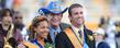 Ivy Lumpkin and Brady Ruffer, 2011 Homecoming Queen and King, are all smiles as they pose for photos with President Lester A. Lefton during halftime ceremonies at Dix Stadium.