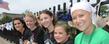 Marissa Manocchio, a Kent State student who is battling cancer, poses with local students who helped collect and display bras for the Bras Across the Crooked River event.