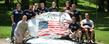 A group of veterans gather around the front campus rock after painting it in honor of current and former military personnel.