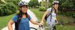 Two students with Flashfleet bikes behind the Library.