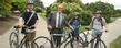 Dr. Robert Frank, provost, poses with students and some of the Flashfleet bikes.