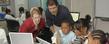 Kent State’s John Dunlosky (right), professor of psychology, and Katherine Rawson (left), associate professor of psychology, help students study in a computer lab.