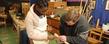 <p>Adam Kuhn, right, works with Katia Melchiades, a teacher from Brazil, on her woodworking project at the Spring Garden Waldorf School near Akron.</p>