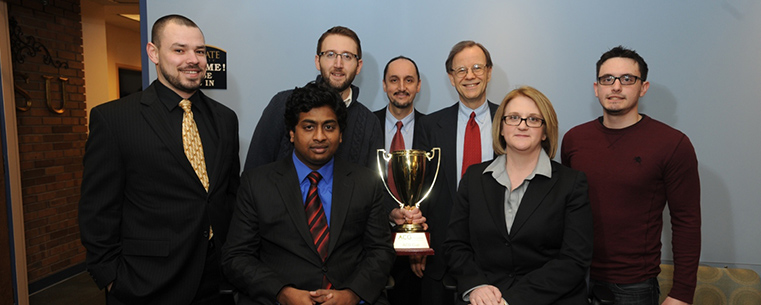 Deborah Spake, dean of Kent State University’s College of Business Administration, was presented with the trophy won by Kent State’s MBA team in the Cleveland Association for Corporate Growth Competition. Spake is surrounded by members of the team: Frank Russ, Josh Hostetler, Brad Neumann and Kaushik Saha (sitting), and Jaume Franquesa, MBA program director, and Doug Lightner, MBA program instructor and team coach.