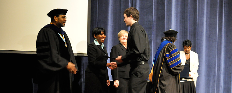 <p style="">A high school student receives a certificate for successfully completing the Upward Bound TRIO Programs' experience at Kent State. Photo by Bruce Mitchell Sr.</p>